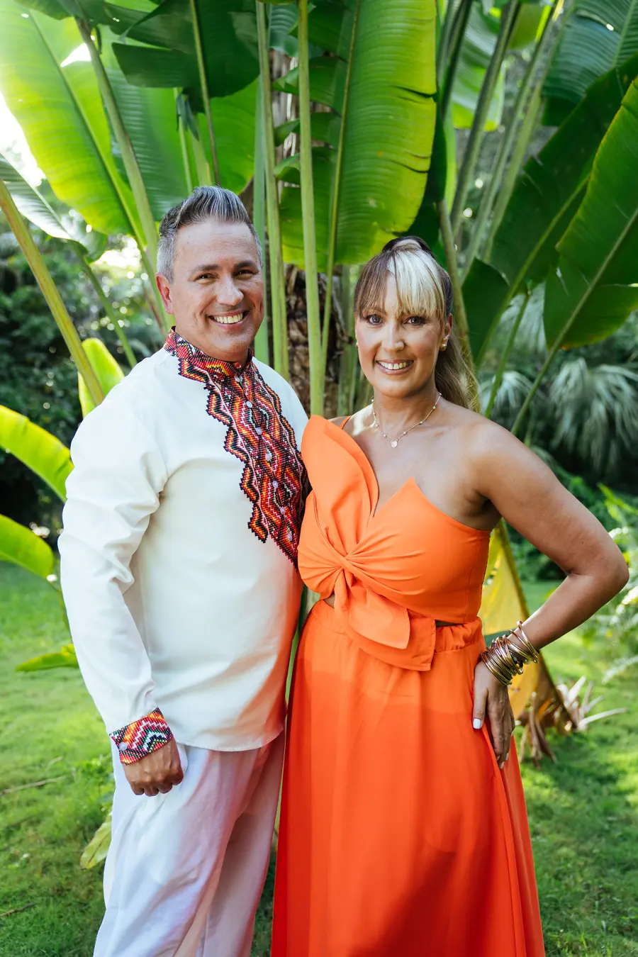 Tania and Abraham side by side in a tropical garden